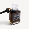 Charm i form af en miniatureparfumeflaske i sort
