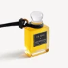 Charm i form af en miniatureparfumeflaske i sort